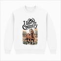 Moletom com estampa frontal de cavalo em ambiente rural, cercado por folhagens e estrutura de madeira, acompanhado da frase "I Love the Country" no topo.