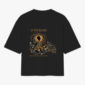 Camiseta com estampa frontal de design intrincado com elementos florais ao redor de texto e estampa traseira de figura mística centralizada com ornamentos detalhados.