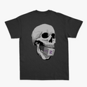 Camiseta com estampa frontal de letras estilizadas "Reals M.C. 4 Anos" em grafite e estampa traseira de um crânio segurando um cartão com símbolo.
