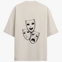 Camiseta com estampa frontal de traço curvado estilizado e estampa traseira de três máscaras teatrais, com uma sorrindo e duas expressando tristeza.