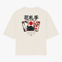 Camiseta com estampa frontal de escrita estilizada "Haganne" e estampa traseira com cartões de Hanafuda, garça, montanha e grafismos japoneses.