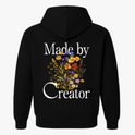 Moletom com estampa frontal de texto estilizado "Made by Creator" no lado superior esquerdo e estampa traseira de flores variadas sob o mesmo texto.