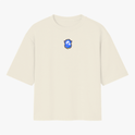 Camiseta com estampa frontal de brasão estilizado e estampa traseira de rosto tribal com "Brasil de Axé" acima e o número "777" em destaque.