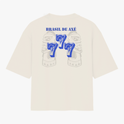 Camiseta com estampa frontal de brasão estilizado e estampa traseira de rosto tribal com "Brasil de Axé" acima e o número "777" em destaque.