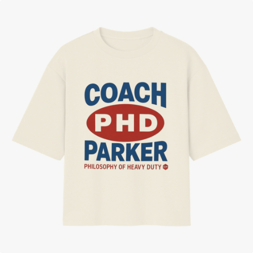 Camiseta com estampa frontal de texto em destaque centralizado, incluindo letras maiúsculas "COACH PHD PARKER" e frase complementar na parte inferior.