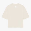 Camiseta com estampa frontal de rosto sorridente decorado com folhas e texto "Elevate Your Frequency" emoldurado por elementos naturais e estampa traseira de símbolo geométrico simples próximo à gola.