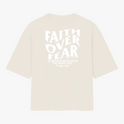 Camiseta com estampa frontal de "Faith Over Fear" com detalhes em texto pequeno e estampa traseira de "Faith Over Fear" acompanhada de citação extensa.