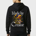 Moletom com estampa frontal de texto estilizado "Made by Creator" no lado superior esquerdo e estampa traseira de flores variadas sob o mesmo texto.