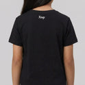 Camiseta com estampa frontal de elementos gráficos geométricos simétricos acompanhados das palavras "Kuarup" e "Xingu", e estampa traseira de "Xingu".