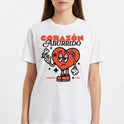 Camiseta com estampa frontal de coração animado segurando uma flor murcha, com adesivo e olhar entediado, rodeado por estrelas e texto "Corazón Aburrido".