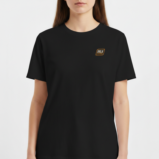 Camiseta com estampa frontal de um emblema pequeno com a palavra "VALA" e estampa traseira com texto "VALA KUSTOM SEM DESCULPAS SEM REMORSOS" e detalhes geométricos.