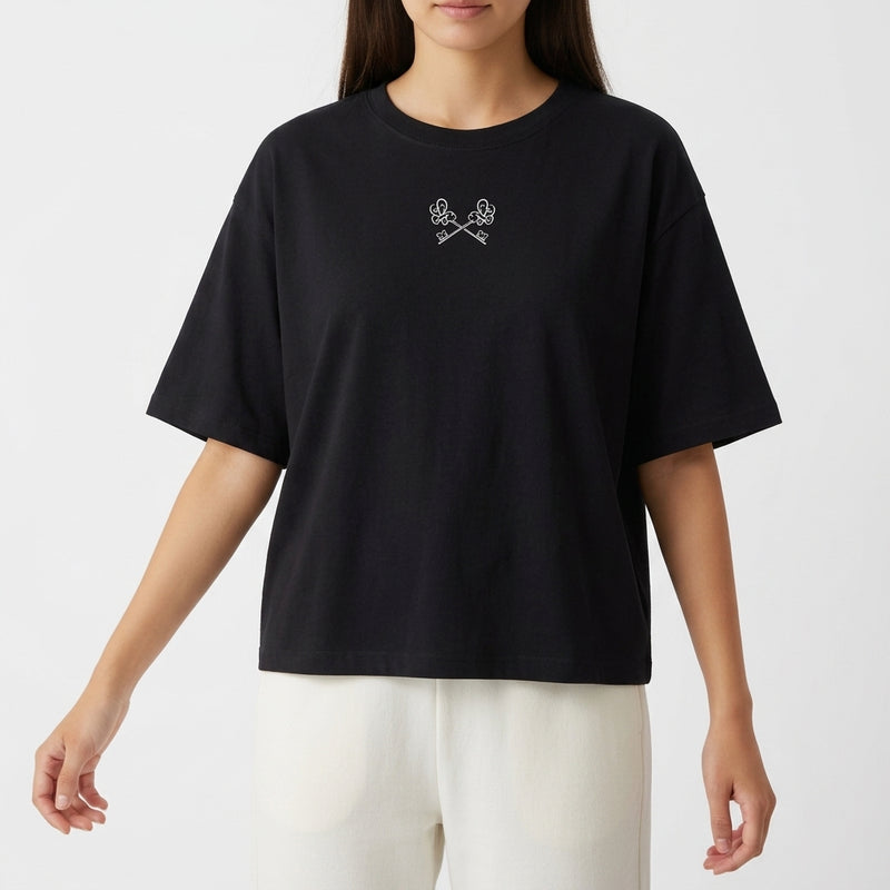 Camiseta com estampa frontal de duas mãos cruzadas segurando um controle de videogame e estampa traseira de design futurista com samurai e texto gráfico.