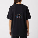 Camiseta com estampa frontal de "Verbo" estilizado centralizado e estampa traseira de frase artística "Ele Vive em Mim" com design tipográfico elegante.