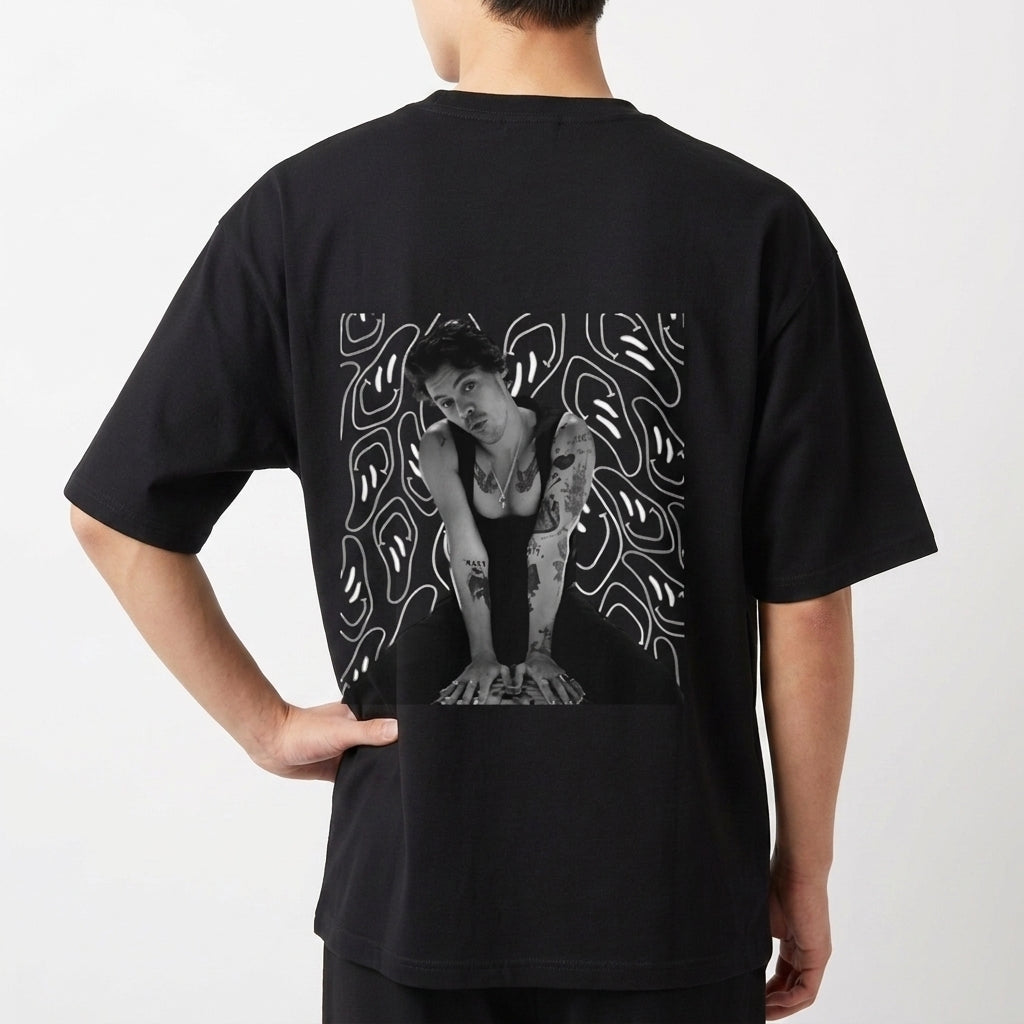 Camiseta com estampa frontal de linha irregular abstrata e estampa traseira de foto de uma pessoa sobre fundo com padrões de linhas fluidas.