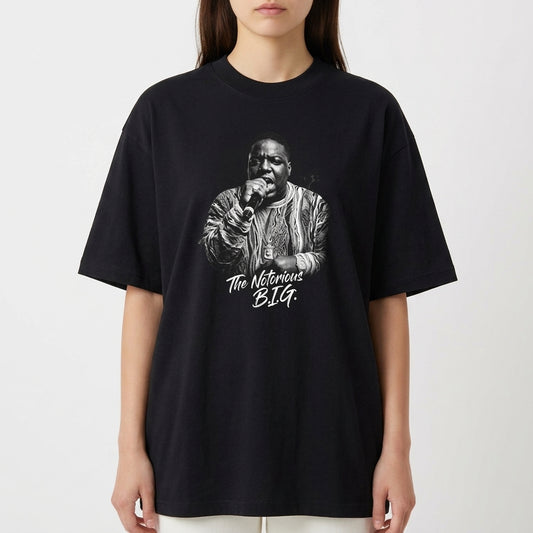 Camiseta com estampa frontal de um artista segurando um microfone e trajando roupa detalhada, acompanhada da inscrição estilizada "The Notorious B.I.G.".