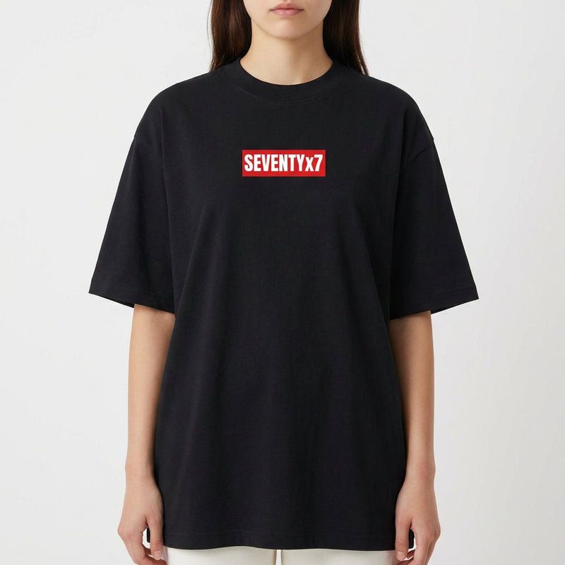 Camiseta com estampa frontal de texto dentro de retângulo pequeno, e estampa traseira de texto pequeno localizado próximo à gola.