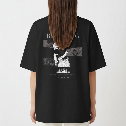 Camiseta com estampa frontal de pequeno retângulo ilustrado e estampa traseira com figuras dinâmicas, texto "The battle is just beginning to crush it" e elementos gráficos.