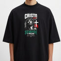 Camiseta com estampa frontal de imagem estilizada de Cristo sob cruz, acompanhada de texto em letras impactantes e elementos gráficos complementares.