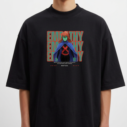 Camiseta com estampa frontal de personagem de capa azul sobre fundo com repetição da palavra "EMPATHY". Texto adicional na parte inferior da imagem.