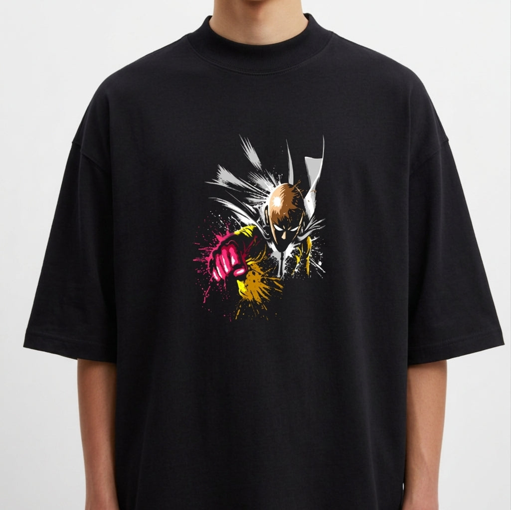 Camiseta com estampa frontal de personagem em pose dinâmica com ação em quadrinhos, destacando soco com efeitos de tinta salpicada.