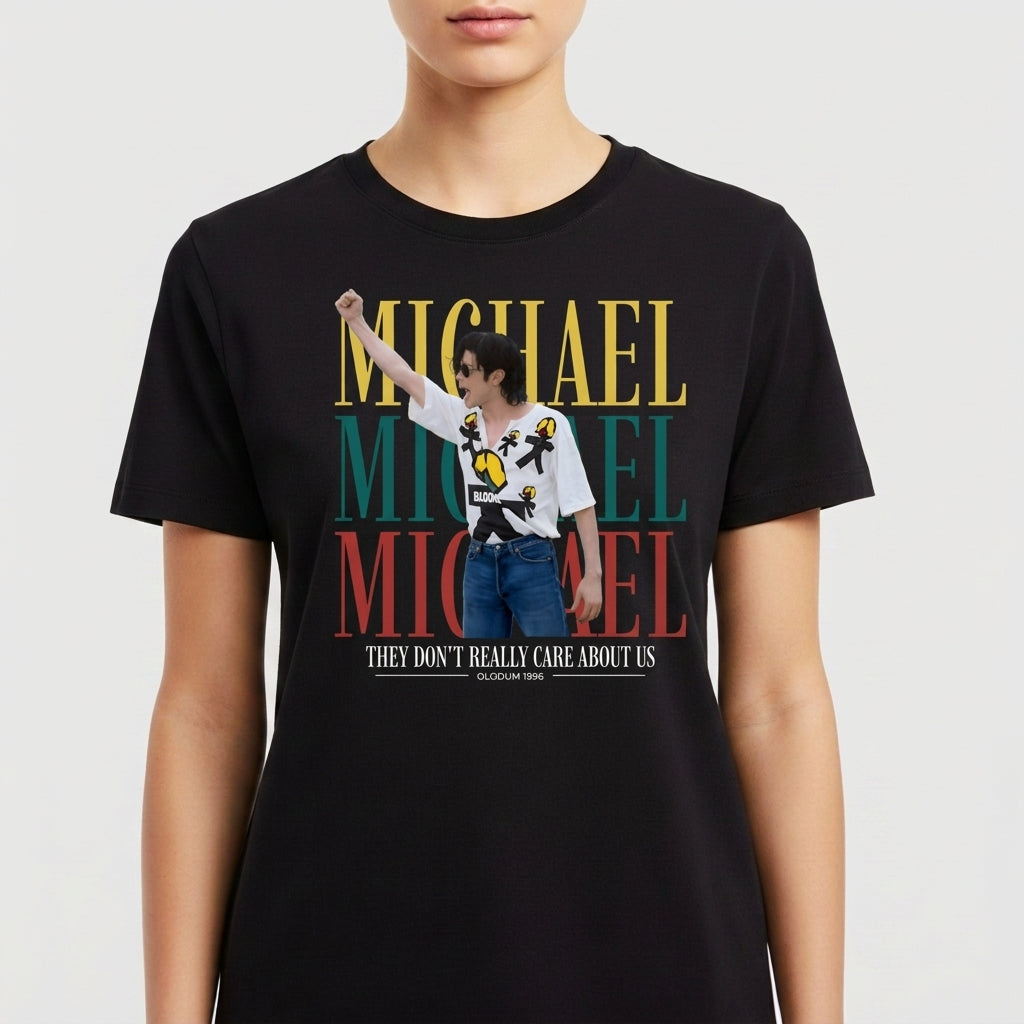 Camiseta com estampa frontal de retrato de artista posando com óculos e camisa decorada, sobreposto ao nome repetido em blocos grandes, e frase adicional.