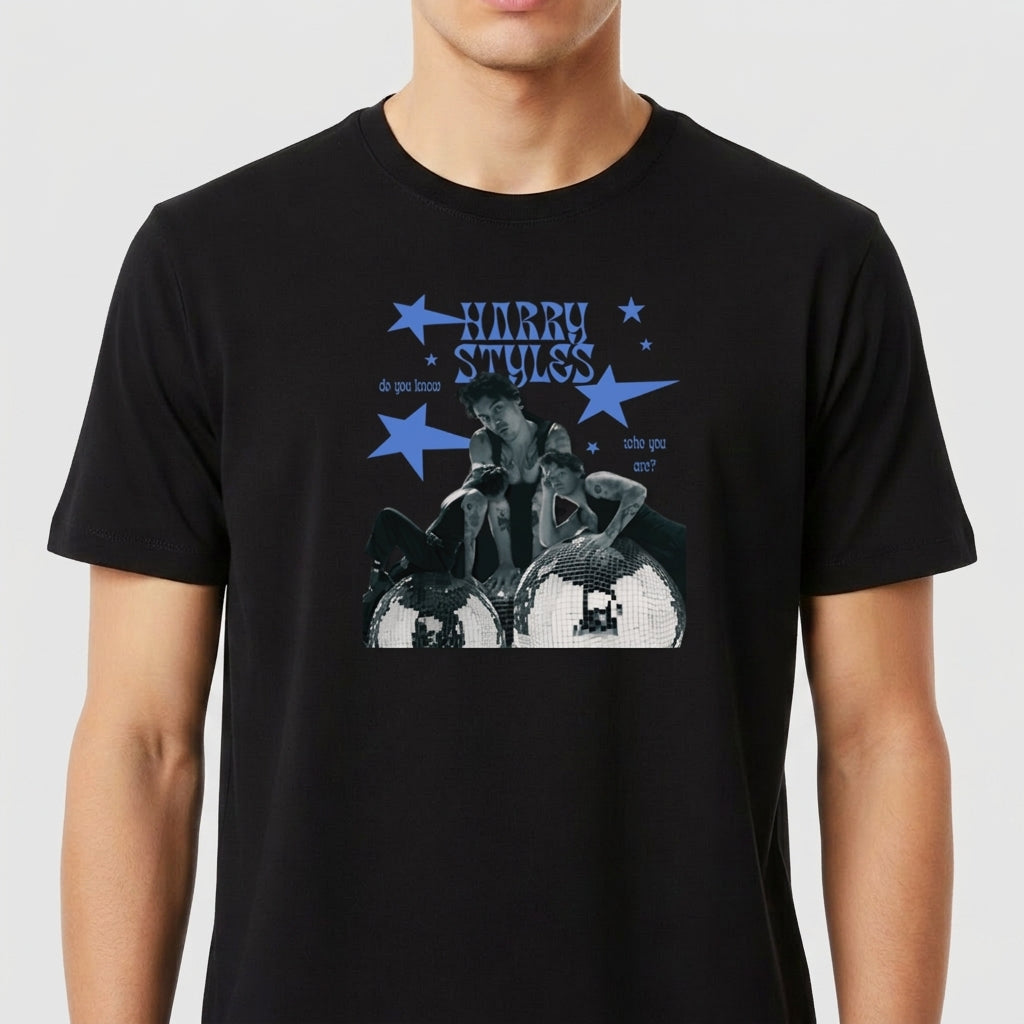 Camiseta com estampa frontal de três pessoas em preto e branco sobre os tambores, cercadas por estrelas azuis e texto estilizado "Harry Styles".